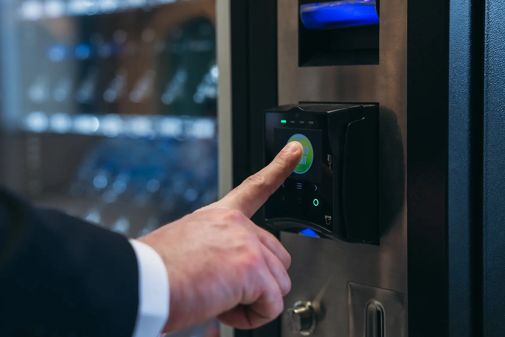 close up hand of man on a vending machine